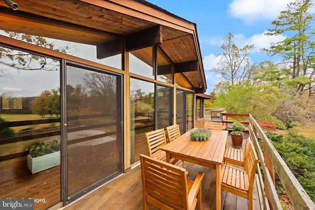 a room with lots of wooden furniture and a large window