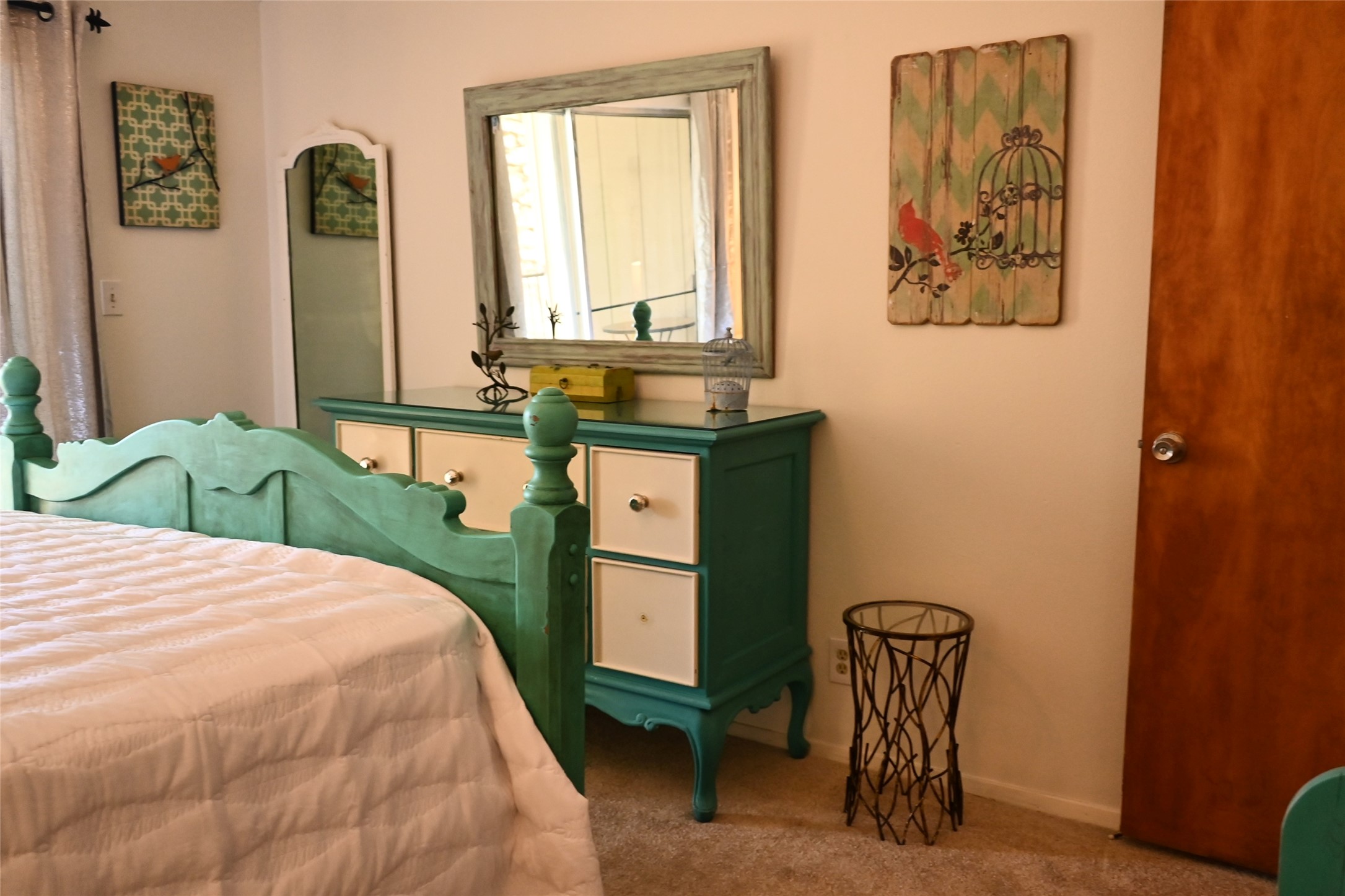 500 East Riverside Drive, Unit 224 Austin, TX 78704 - Photo 17 of 19 A well-lit bedroom with soft carpeting and warm, neutral wall tones, creating a tranquil retreat.