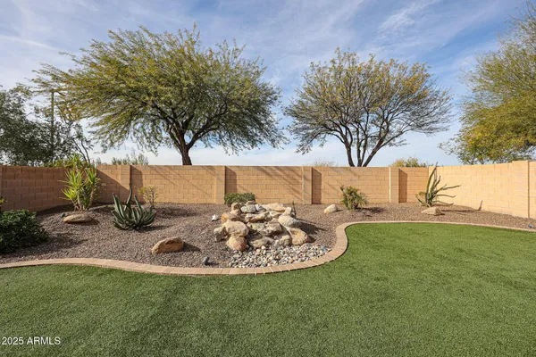 a view of a backyard with table and chairs and a fire pit