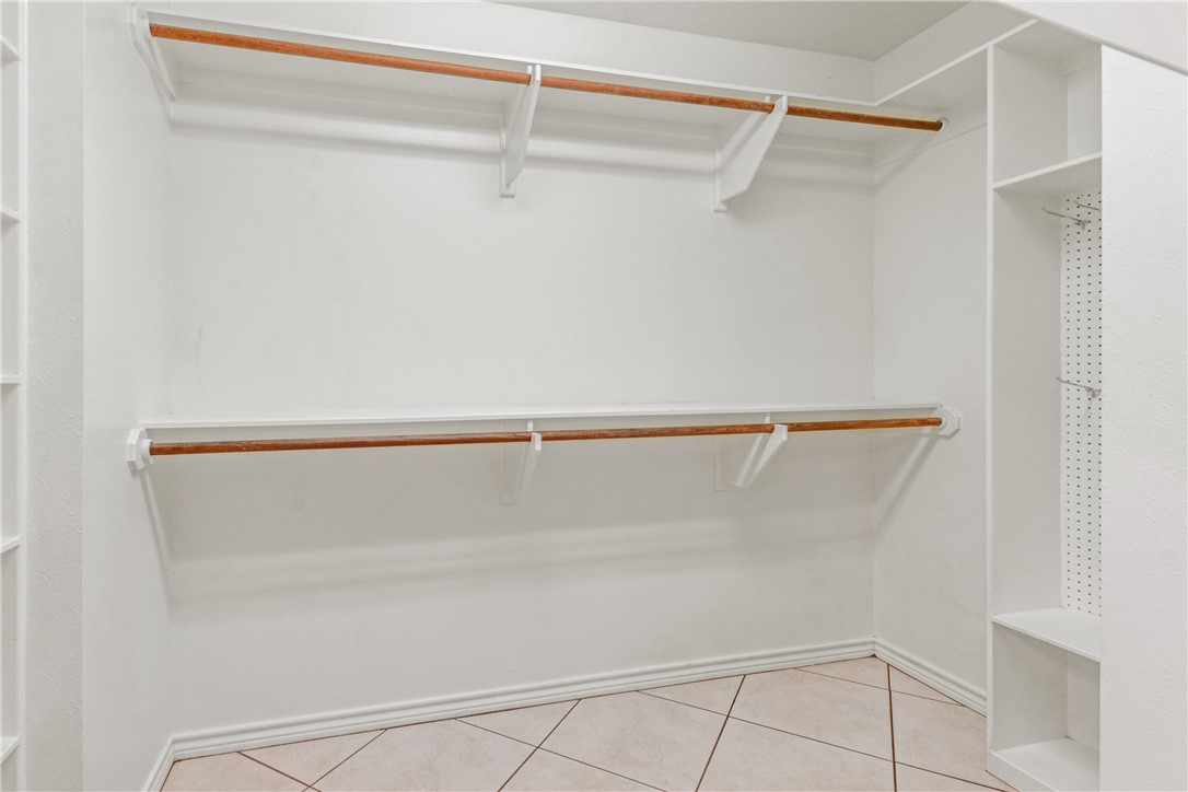 9997 Calhoun Road Bryan, TX 77808 - Photo 21 of 50 a view of walk in closet with empty racks