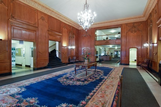 5555 North Sheridan Road, Unit 1504 Chicago, IL 60640 - Photo 2 of 18 a living room with fireplace furniture and a chandelier