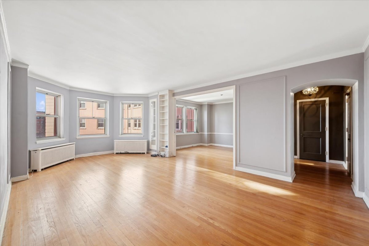 5555 North Sheridan Road, Unit 1504 Chicago, IL 60640 - Photo 3 of 18 a view of an empty room with window and wooden floor