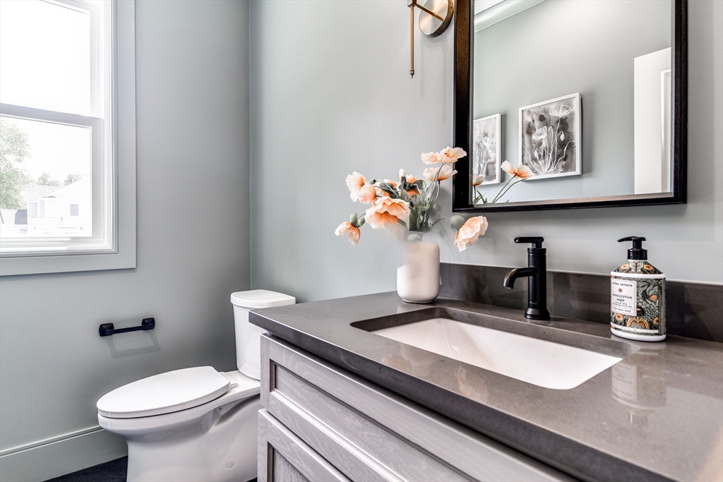 1 Winter Street Natick, MA 01760 - Photo 14 of 26 a bathroom with a granite countertop sink mirror and toilet