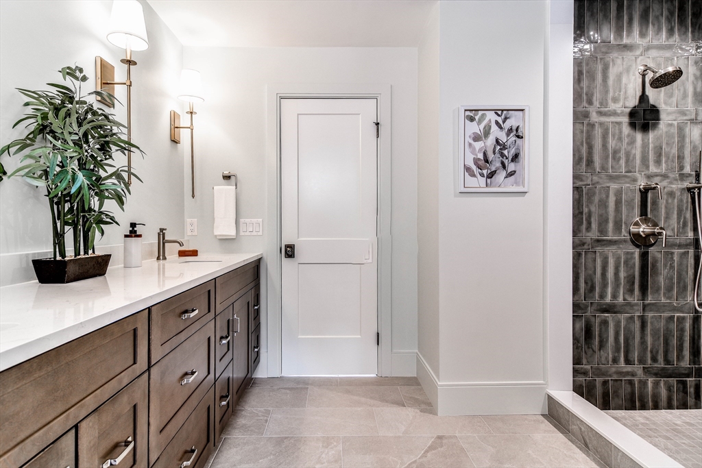 1 Winter Street Natick, MA 01760 - Photo 17 of 26 a spacious bathroom with a double vanity sink a mirror and shower