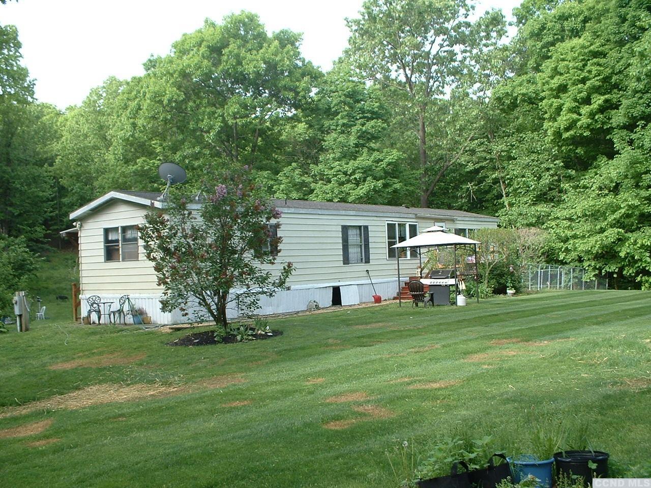 a view of a house with a backyard