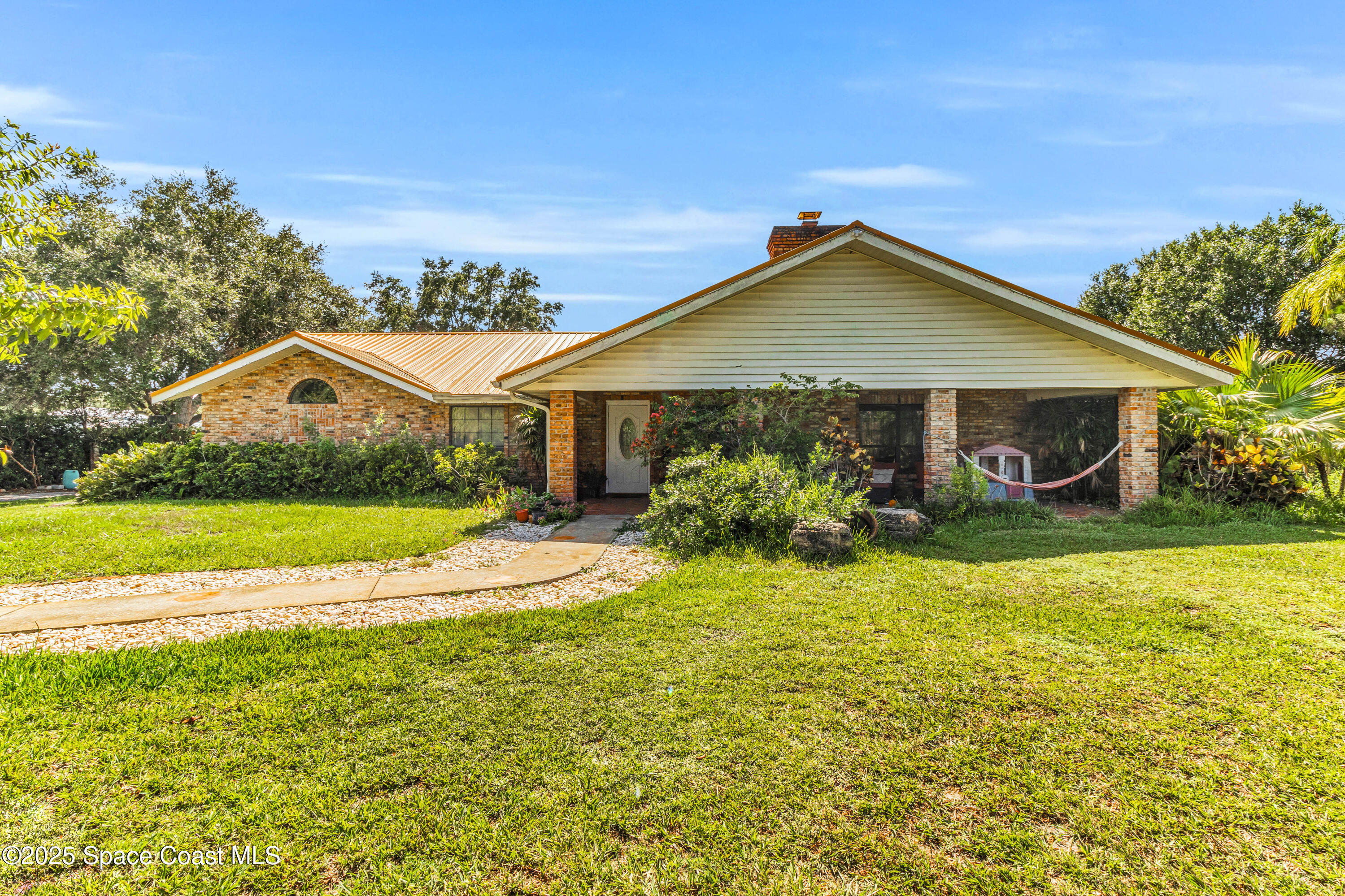 1980 Corey Road Malabar, FL 32950 - Photo 1 of 42 a view of a house with swimming pool and yard