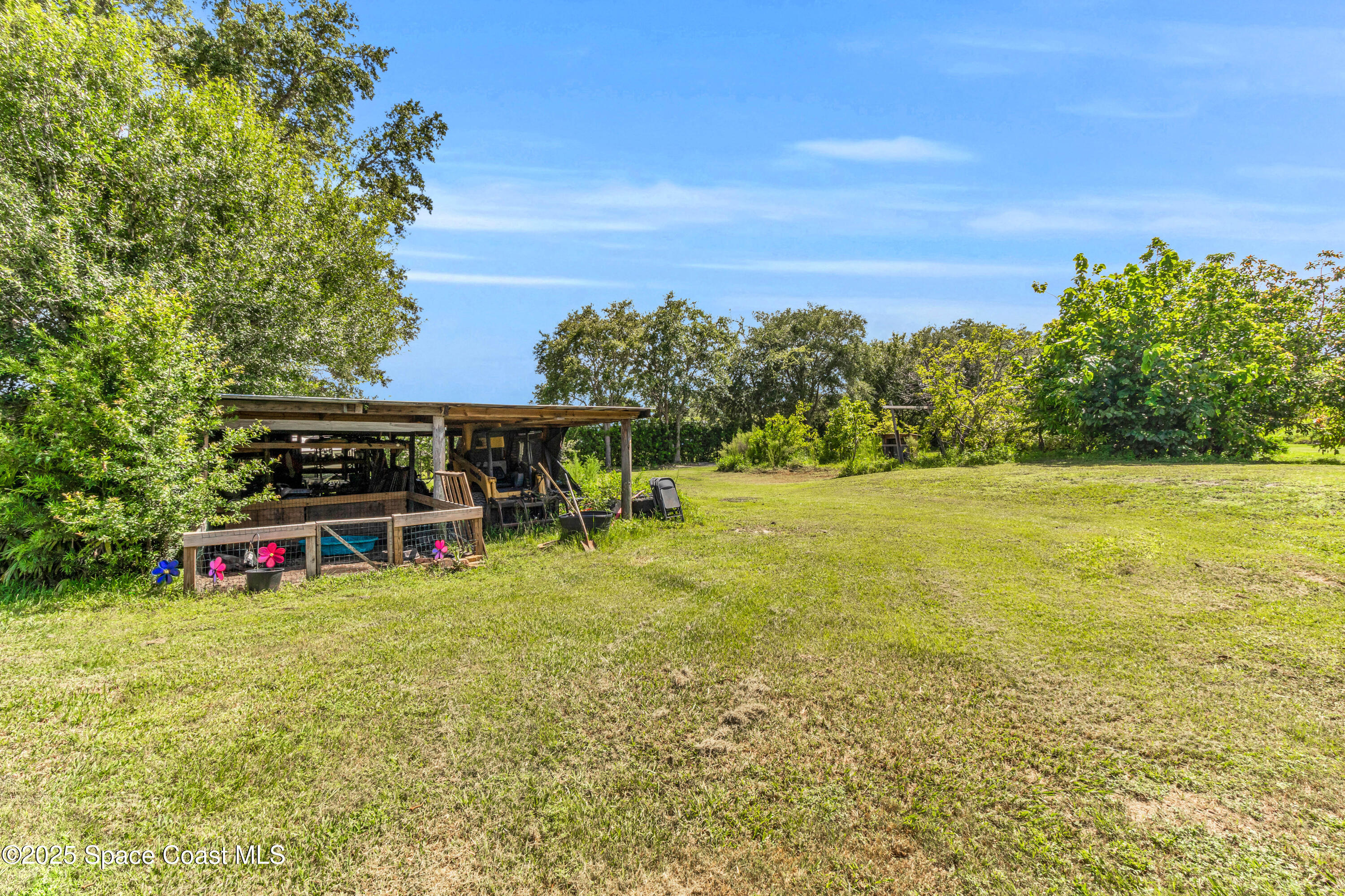 1980 Corey Road Malabar, FL 32950 - Photo 12 of 42 a view of a field with some trees in the background