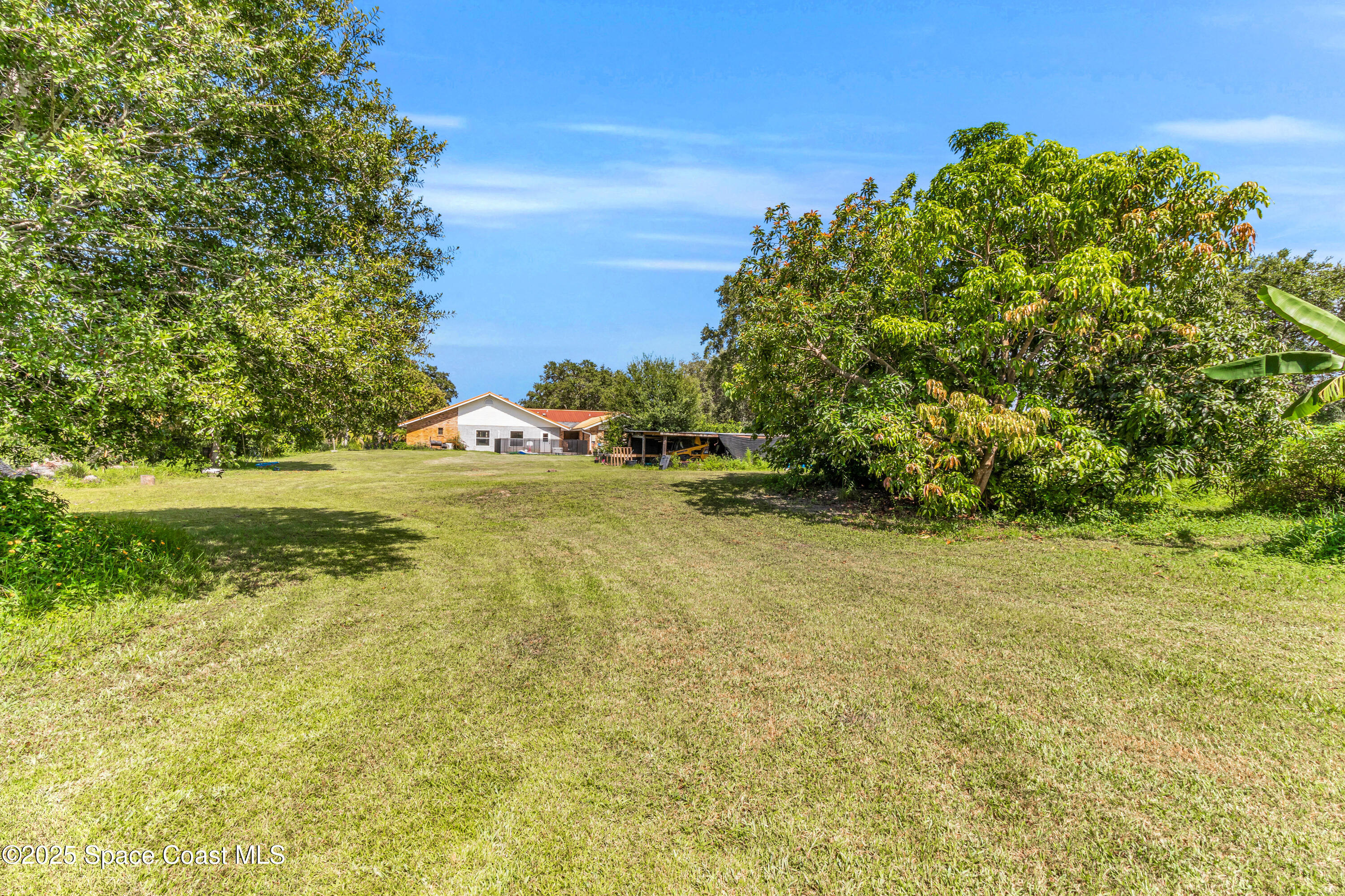 1980 Corey Road Malabar, FL 32950 - Photo 13 of 42 a view of a field with an trees in the background