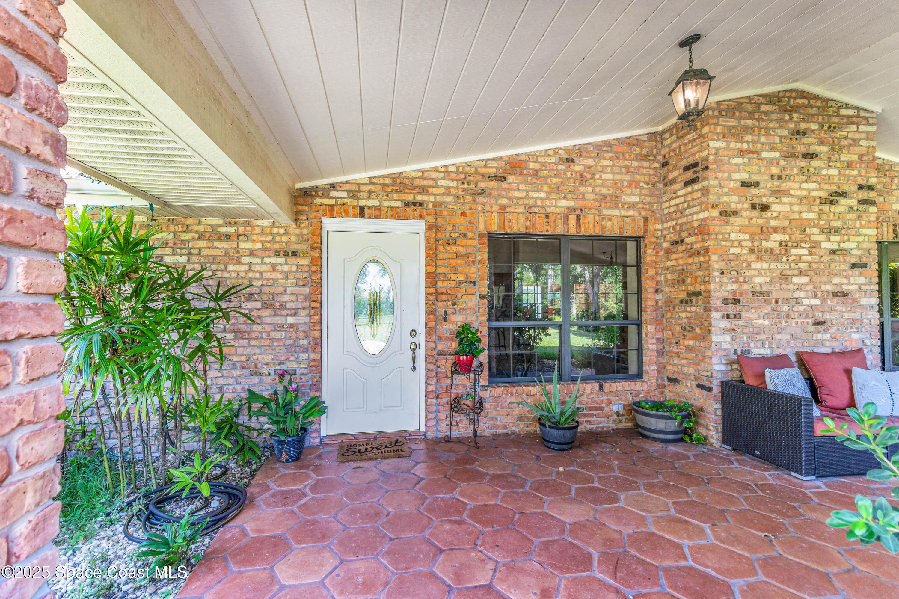 1980 Corey Road Malabar, FL 32950 - Photo 17 of 42 a view of a patio with table and chairs and potted plants