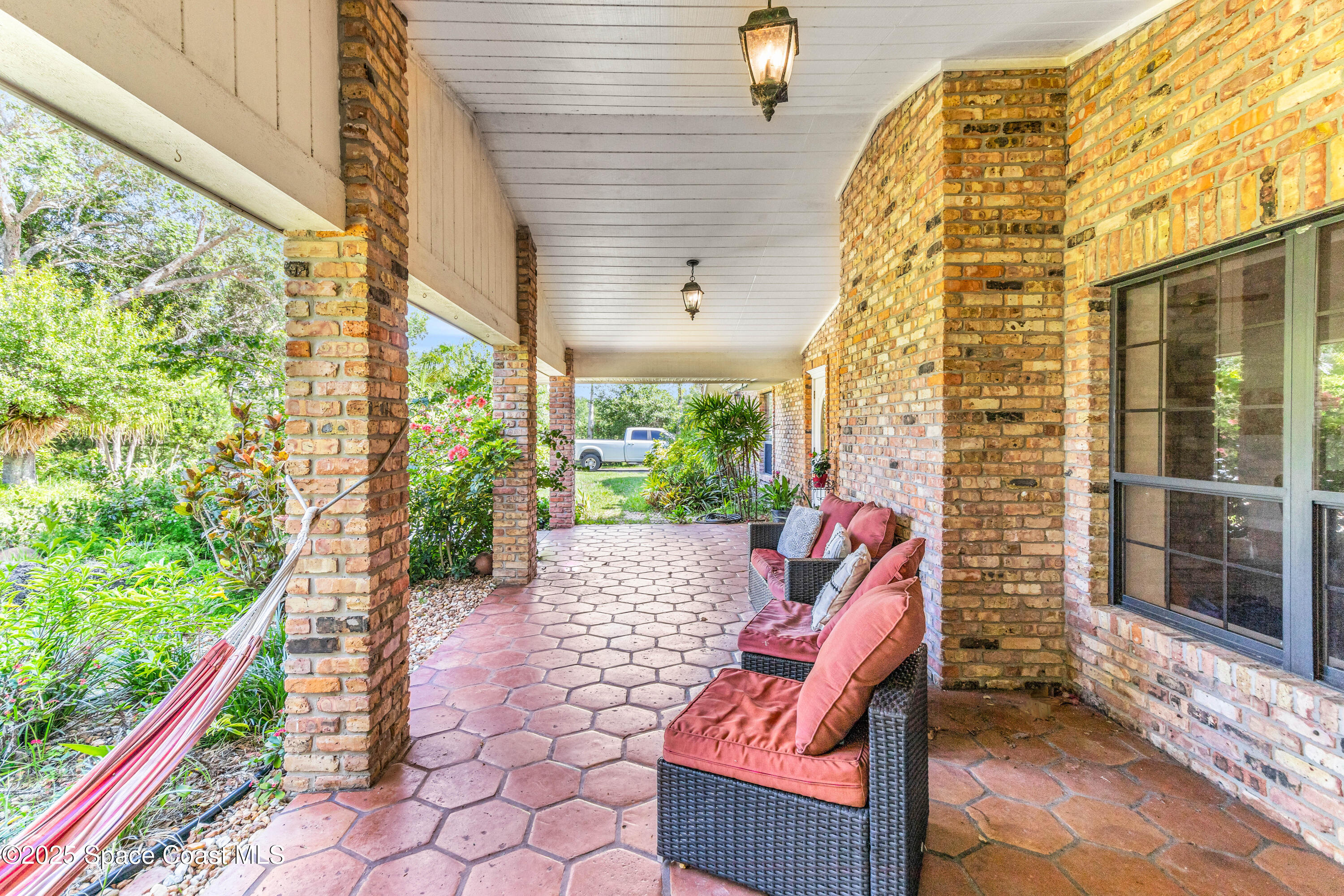 1980 Corey Road Malabar, FL 32950 - Photo 18 of 42 a backyard of a house with outdoor seating