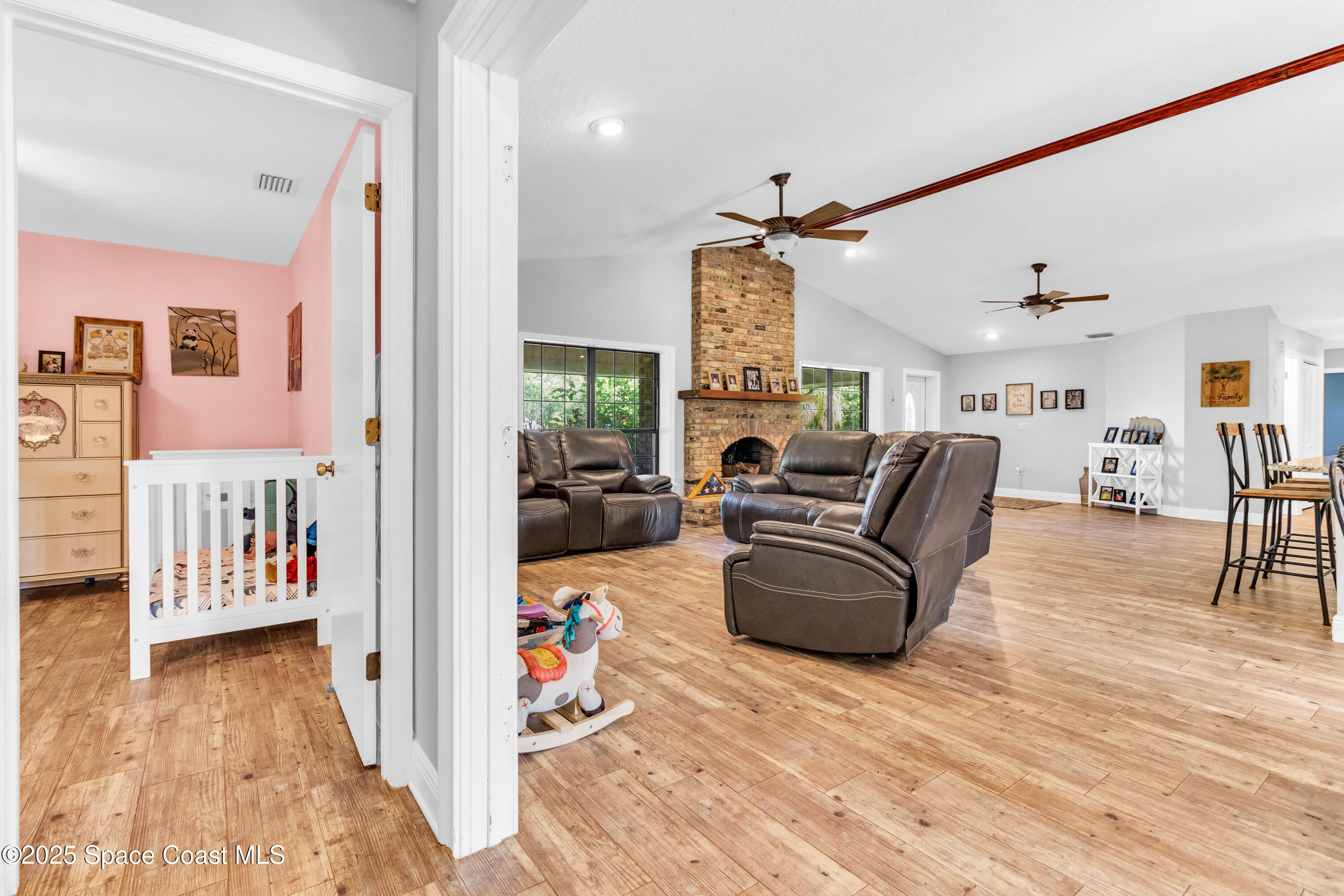 1980 Corey Road Malabar, FL 32950 - Photo 24 of 42 a living room with furniture and a wooden floor