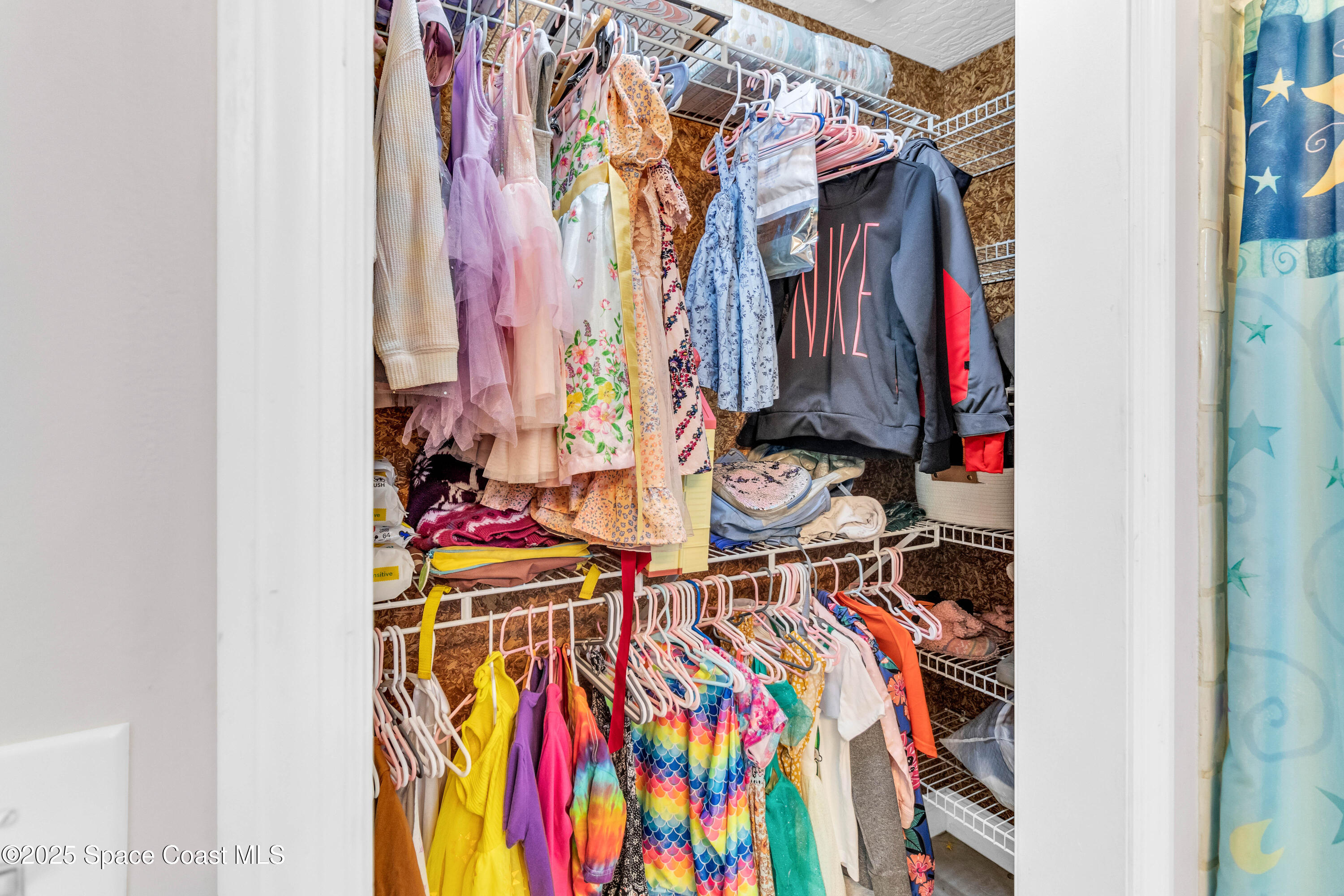 1980 Corey Road Malabar, FL 32950 - Photo 26 of 42 a view of walk in closet with clothes