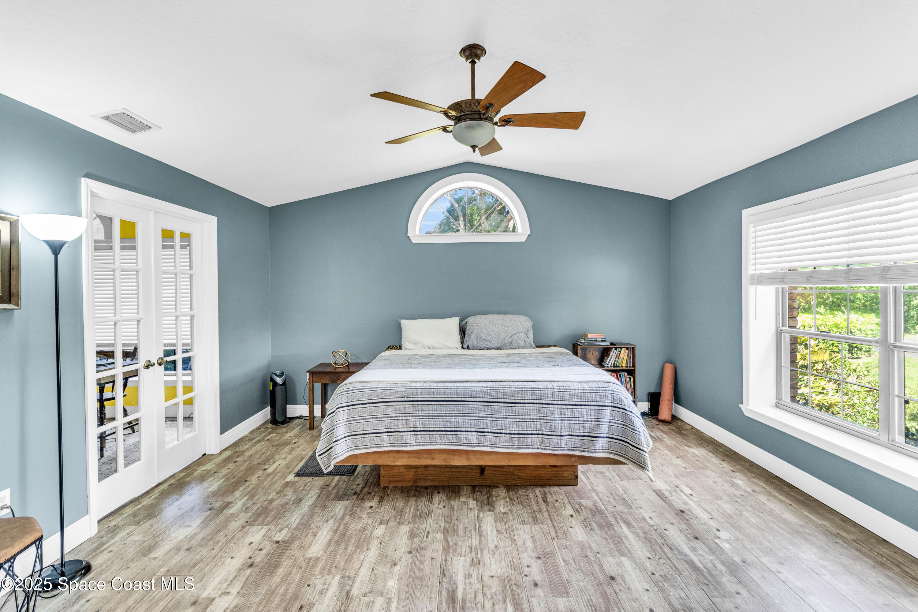 1980 Corey Road Malabar, FL 32950 - Photo 35 of 42 a bedroom with a bed and a large window