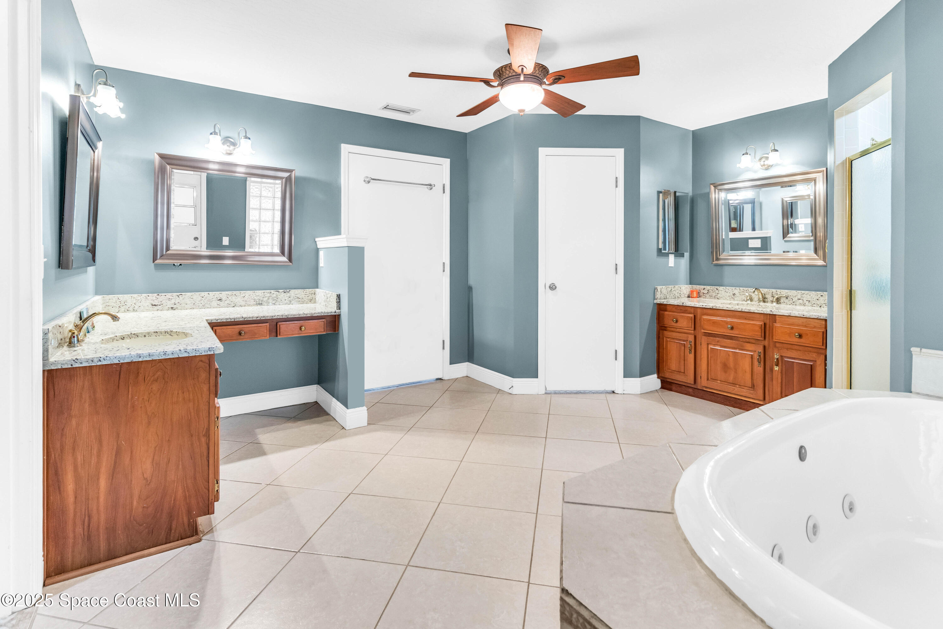 1980 Corey Road Malabar, FL 32950 - Photo 40 of 42 a spacious bathroom with a tub sink and mirror