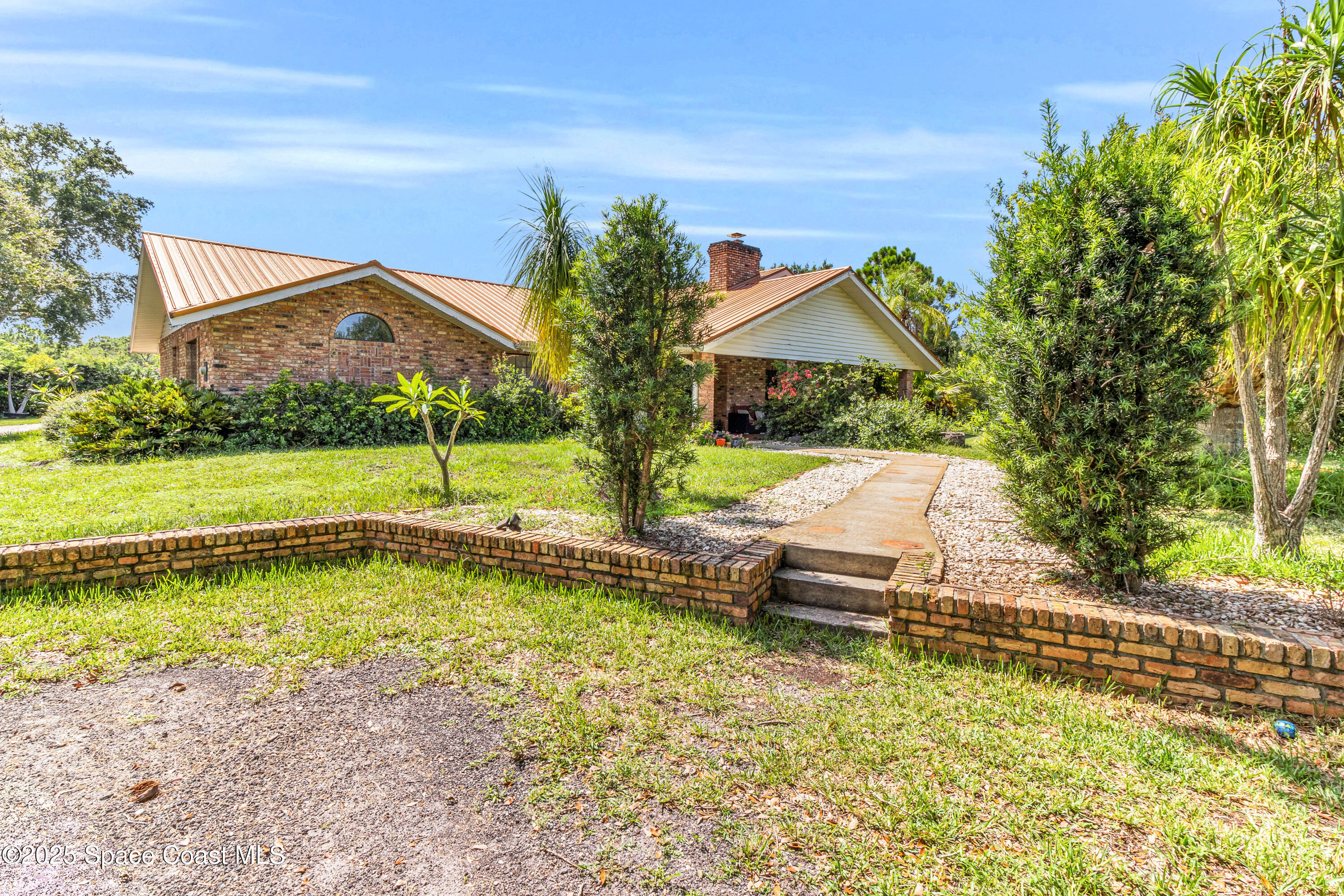 1980 Corey Road Malabar, FL 32950 - Photo 8 of 42 a front view of a house with a yard