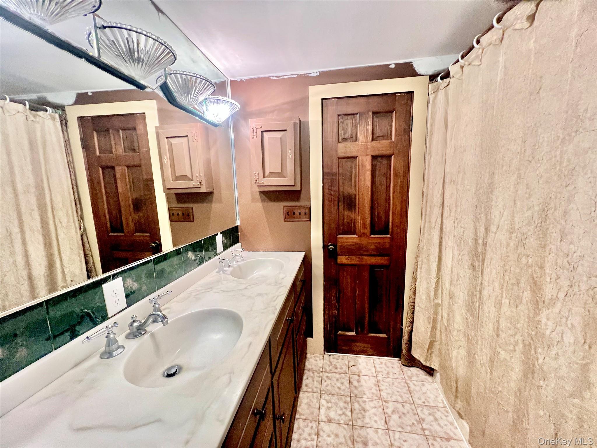 57 Hubbard Road Middletown, NY 10940 - Photo 20 of 30 a bathroom with a sink a mirror and shower