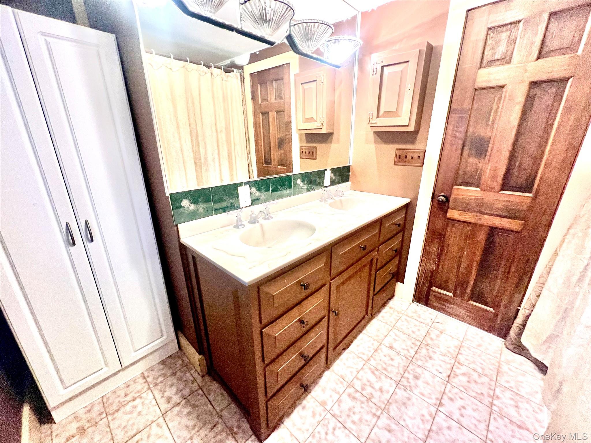 57 Hubbard Road Middletown, NY 10940 - Photo 22 of 30 a bathroom with a sink and a mirror