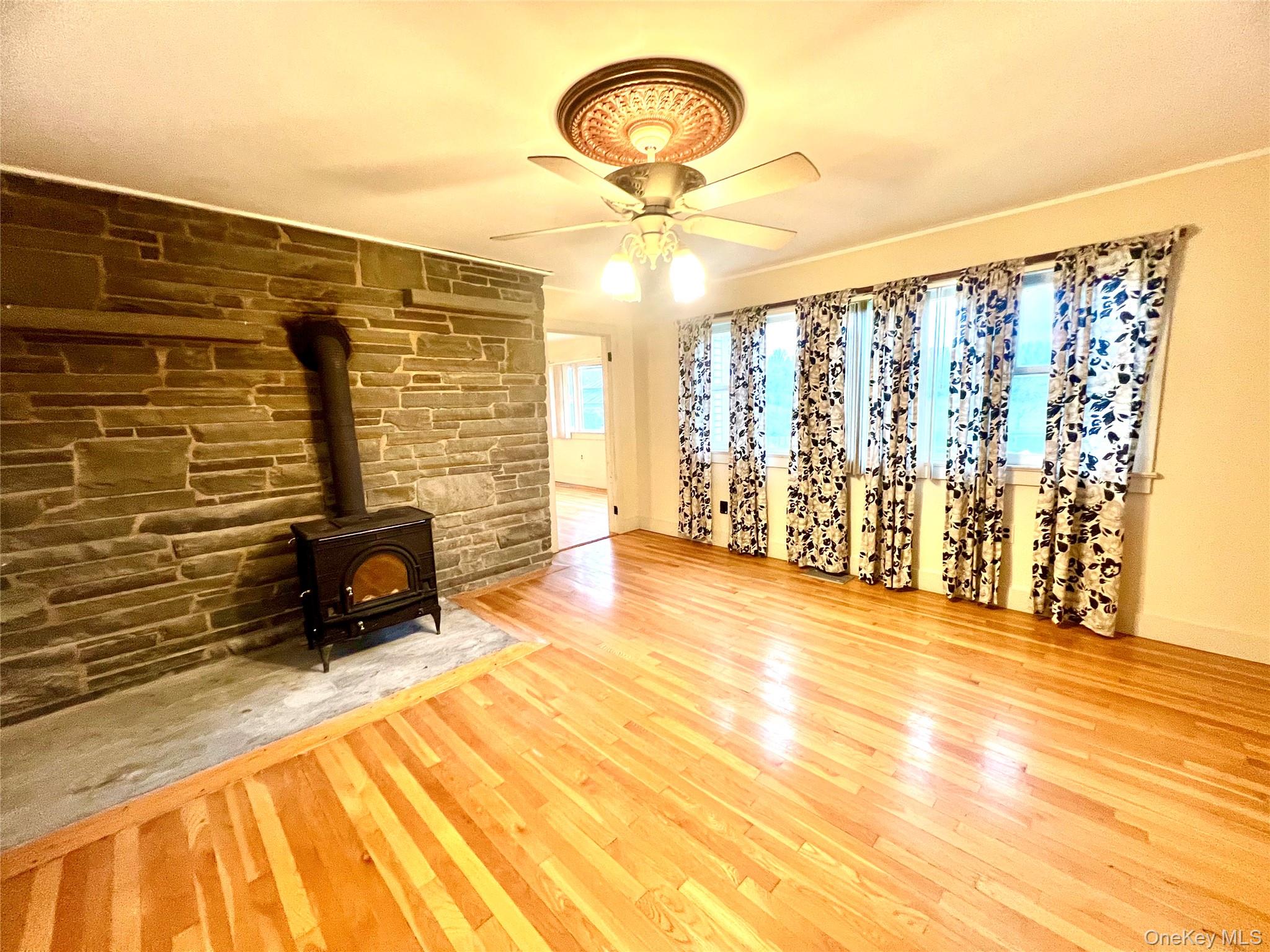 57 Hubbard Road Middletown, NY 10940 - Photo 7 of 30 a view of a livingroom with wooden floor and a ceiling fan