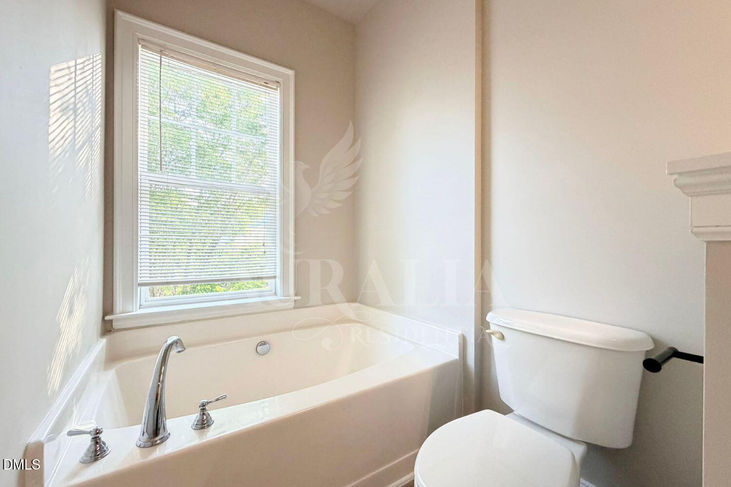 7754 ACC Boulevard Raleigh, NC 27617 - Photo 31 of 41 a white toilet sitting next to a bath tub