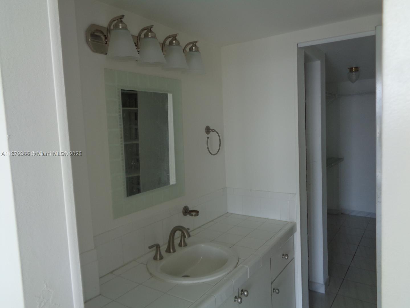 Allapattah Miami, FL 33142 - Photo 22 of 46 a bathroom with a sink and mirror