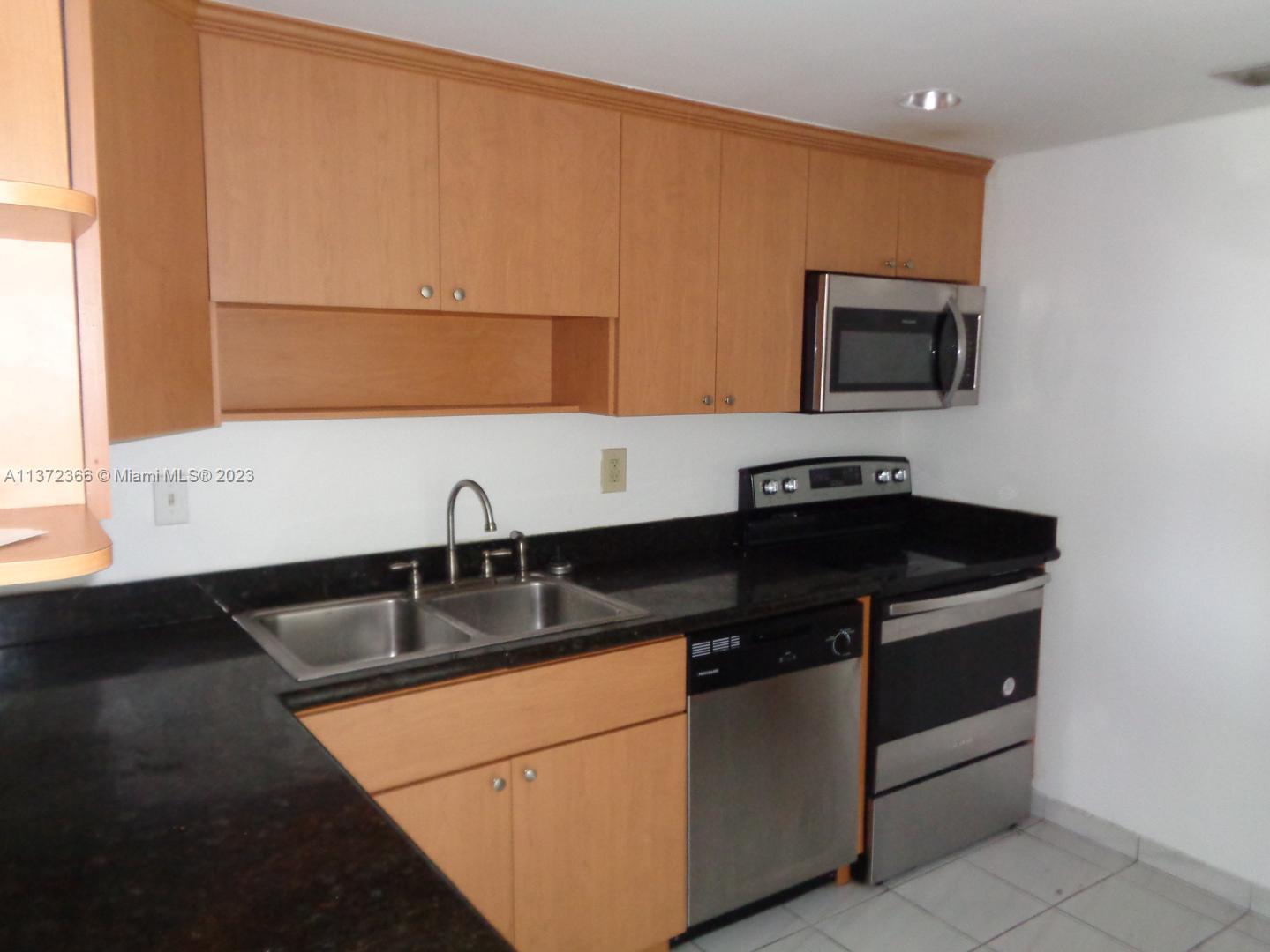 Allapattah Miami, FL 33142 - Photo 23 of 46 a close view of a sink and a microwave oven in a kitchen