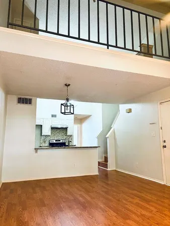 a view of a kitchen with furniture and wooden floor