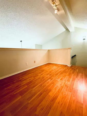 a view of a room with wooden floor