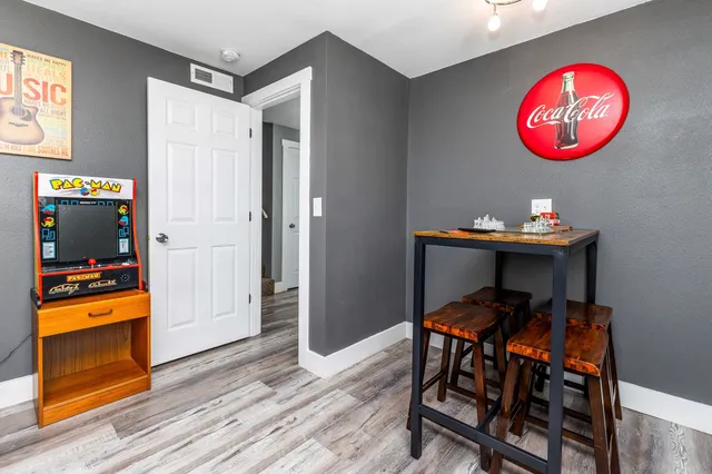 a bedroom with a large bed and a chandelier