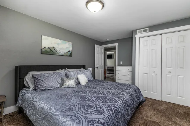 a bedroom with a large bed and a window