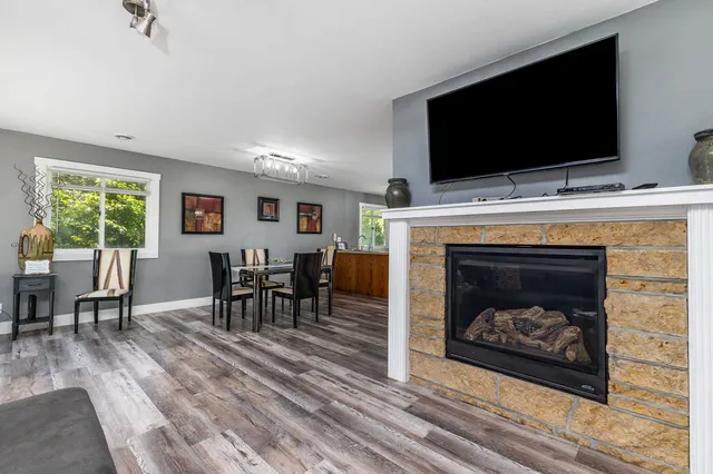 a living room with furniture a fireplace and a flat screen tv