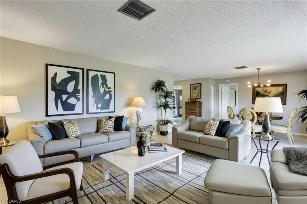355-Palm-Dr-732-Naples-FL-Living room - virtual staged -with suspended lighting and a textured ceiling