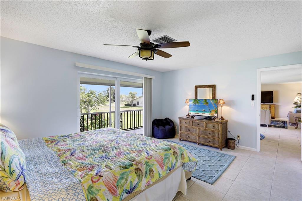 355 Palm Drive, Unit 732 Naples, FL 34112 - Photo 12 of 44 a bedroom with a bed a couch and a window