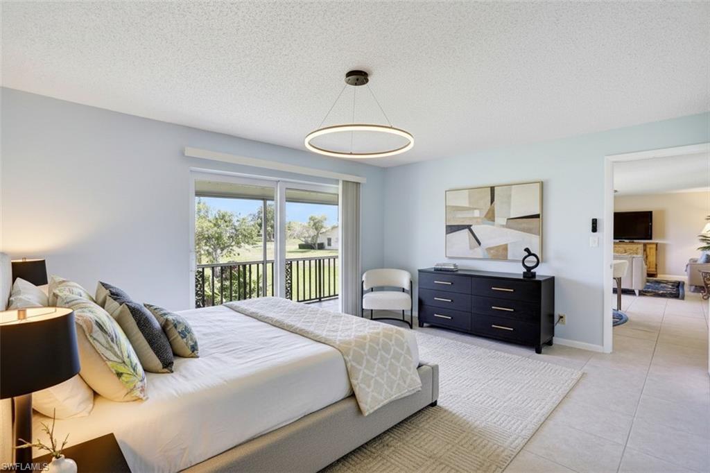 355 Palm Drive, Unit 732 Naples, FL 34112 - Photo 20 of 50 Bedroom - virtual staged - with access to outside, a textured ceiling, and light tile patterned floors