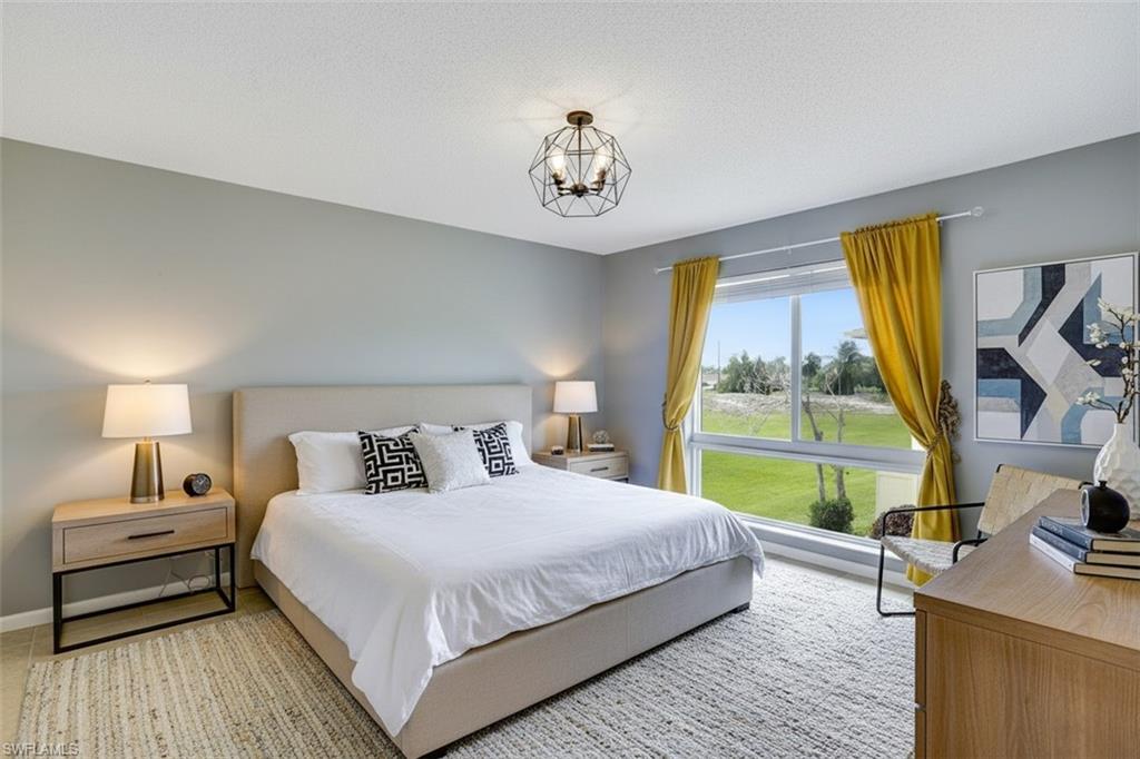 355 Palm Drive, Unit 732 Naples, FL 34112 - Photo 26 of 50 Bedroom virtual staged featuring suspended lighting and a textured ceiling