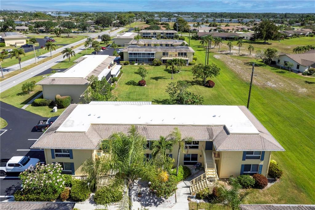 355 Palm Drive, Unit 732 Naples, FL 34112 - Photo 27 of 44 an aerial view of a house with a lake view