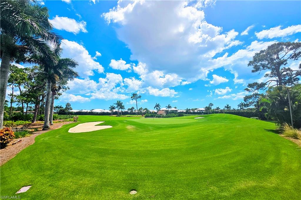355 Palm Drive, Unit 732 Naples, FL 34112 - Photo 43 of 44 a view of a golf course with yellow lighting