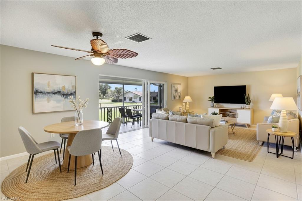 355 Palm Drive, Unit 732 Naples, FL 34112 - Photo 6 of 50 355-Palm-Dr-732-Naples-FL-Living area-virtual staged- with light tile patterned flooring, a textured ceiling, and a ceiling fan