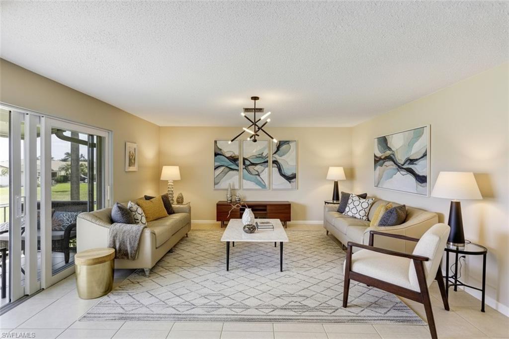 355 Palm Drive, Unit 732 Naples, FL 34112 - Photo 8 of 50 Living area virtual staged -featuring suspended lighting, a textured ceiling, and light tile patterned flooring