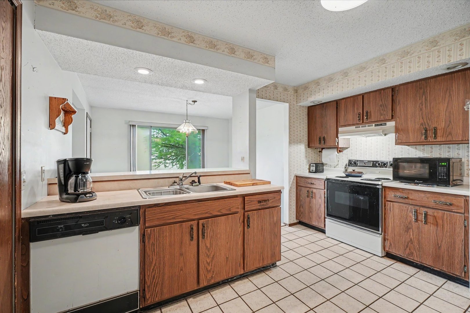 711 Higgins Road Champaign, IL 61822 - Photo 10 of 23 a kitchen with a sink stove and cabinets