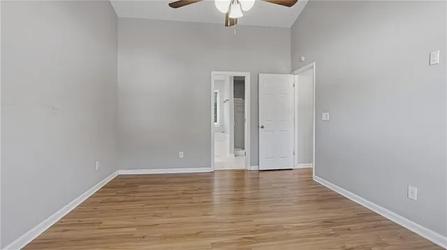 a view of room with hardwood floor and ceiling fan
