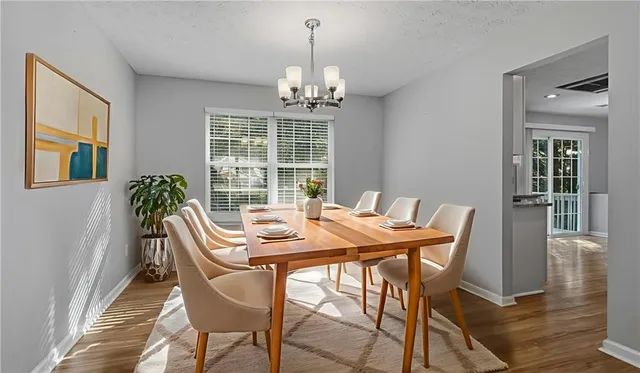 a view of a dining room with furniture window and wooden floor