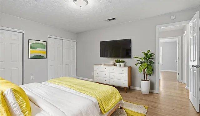 a bedroom with a bed and a flat screen tv