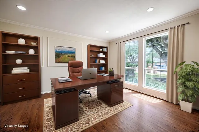 a view of a workspace with furniture and a window