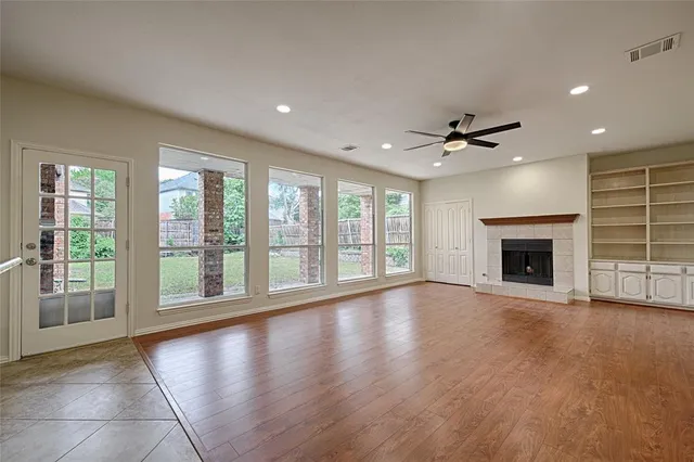 a view of an empty room with a fireplace and a floor to ceiling window