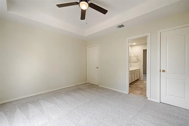 an empty room with a empty space and a ceiling fan