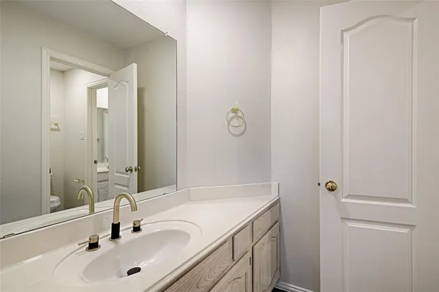 a view of a room with a ceiling fan and window