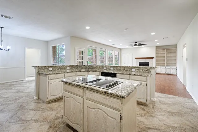 a kitchen with a stove sink and cabinets