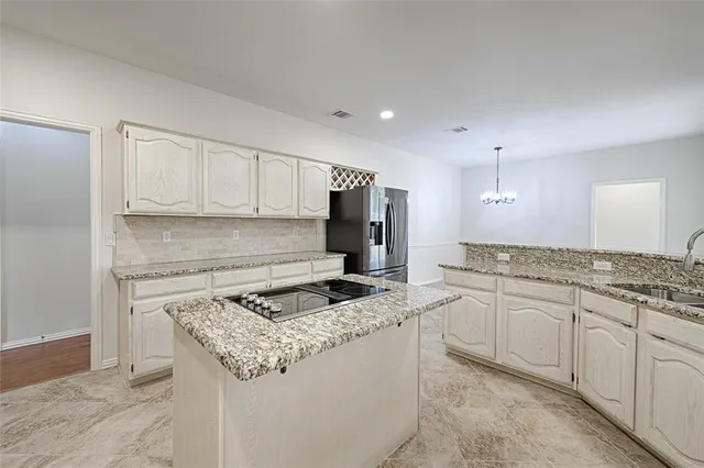 a kitchen that has a sink and a stove in it