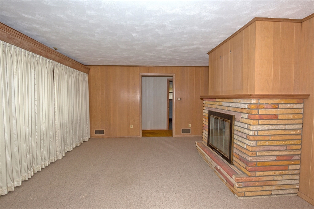104 D Four Bridges Road Somers, CT 06071 - Photo 13 of 40 a view of a livingroom with an empty space and a fireplace