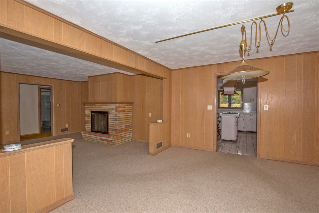 104 D Four Bridges Road Somers, CT 06071 - Photo 15 of 40 a view of a livingroom with an empty space and a fireplace